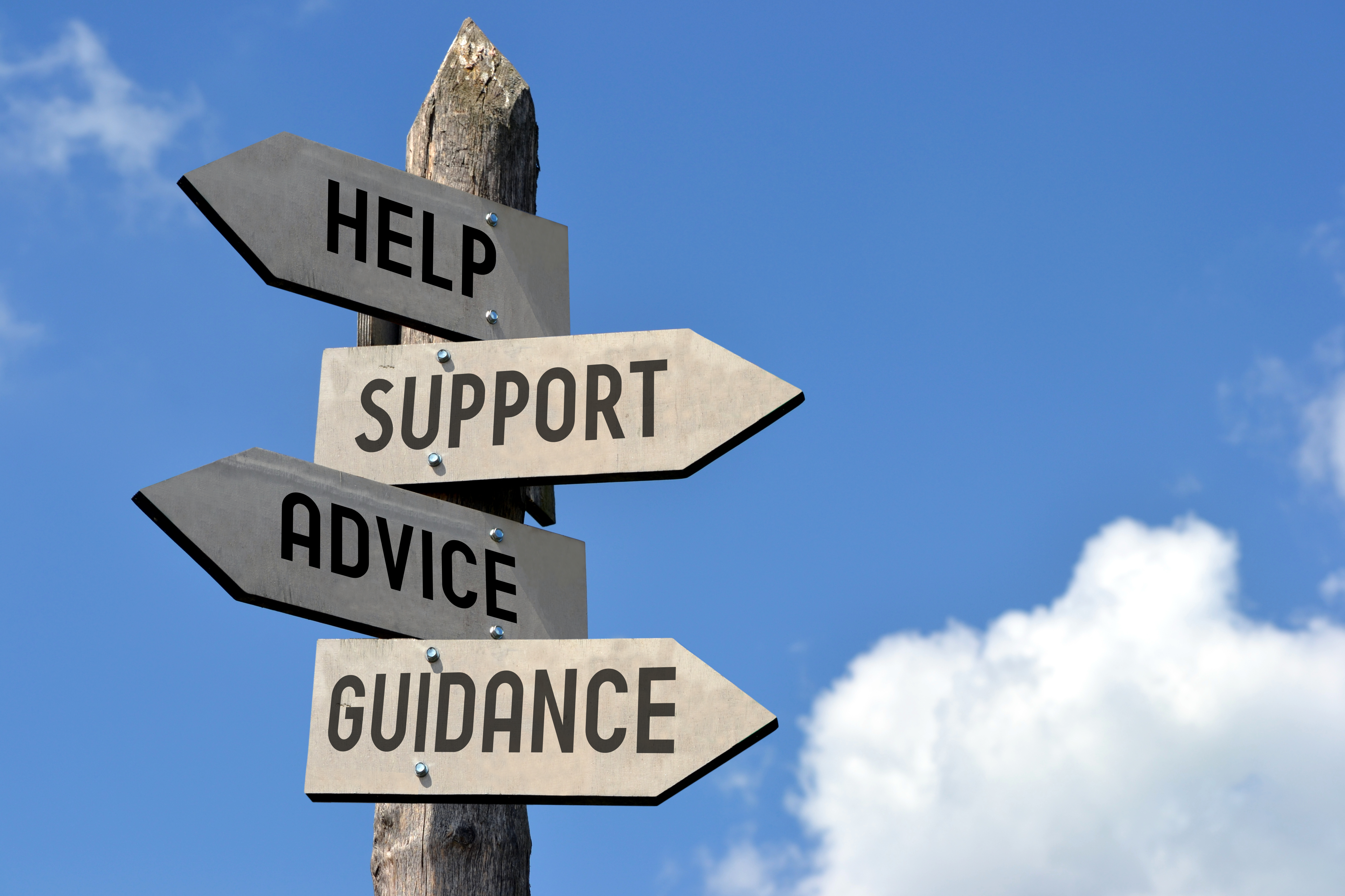 a signpost with signs for Help, Support, Guidance, and Advice